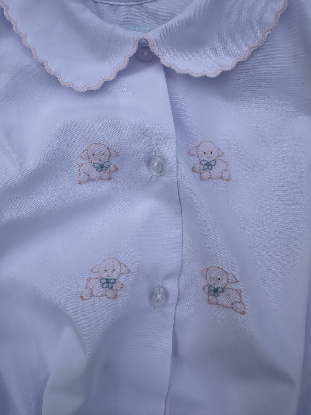 White Bubble with embroidered lamb designs on a plain background