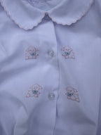 White Bubble with embroidered lamb designs on a plain background