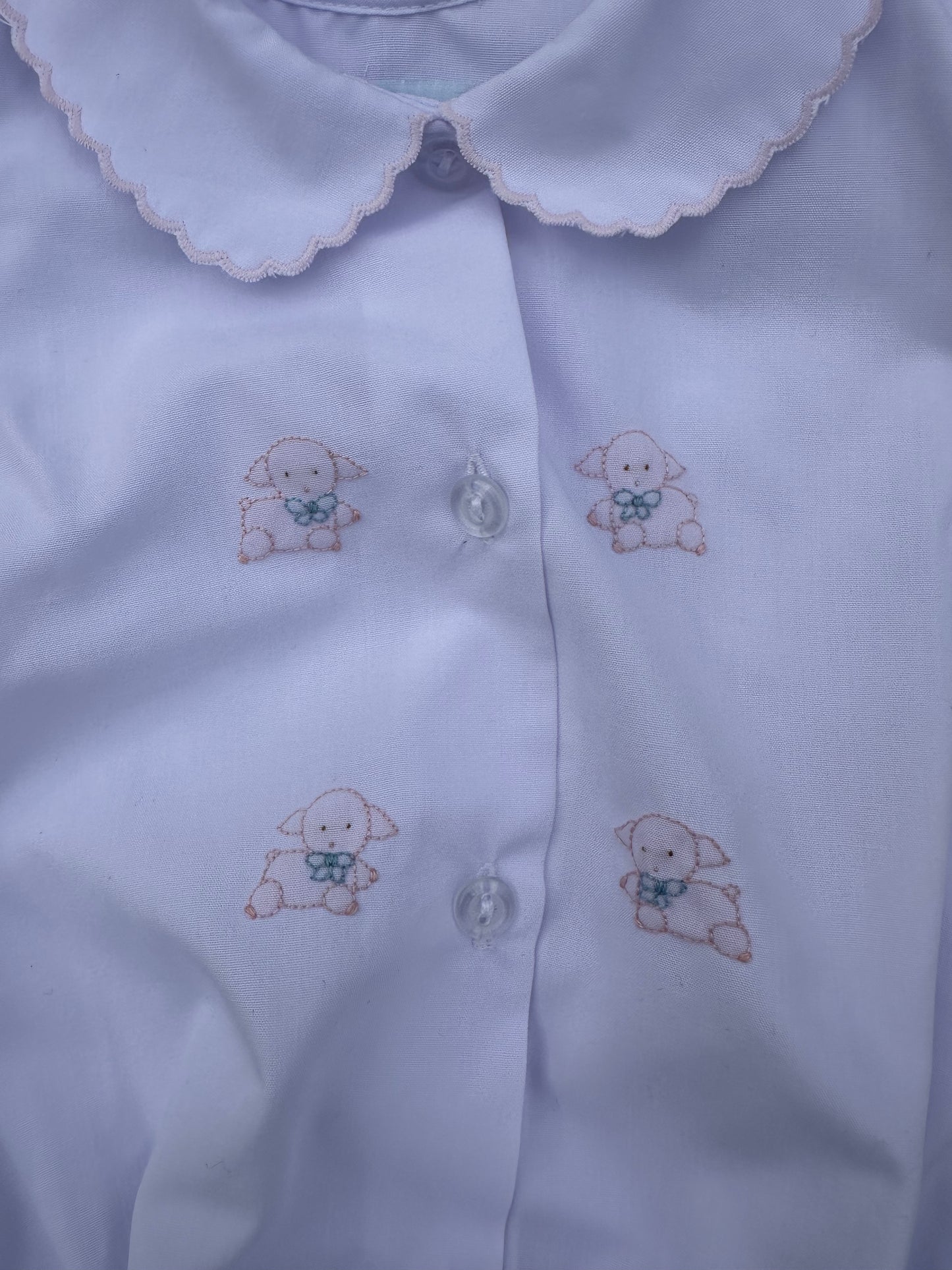 White Bubble with embroidered lamb designs on a plain background