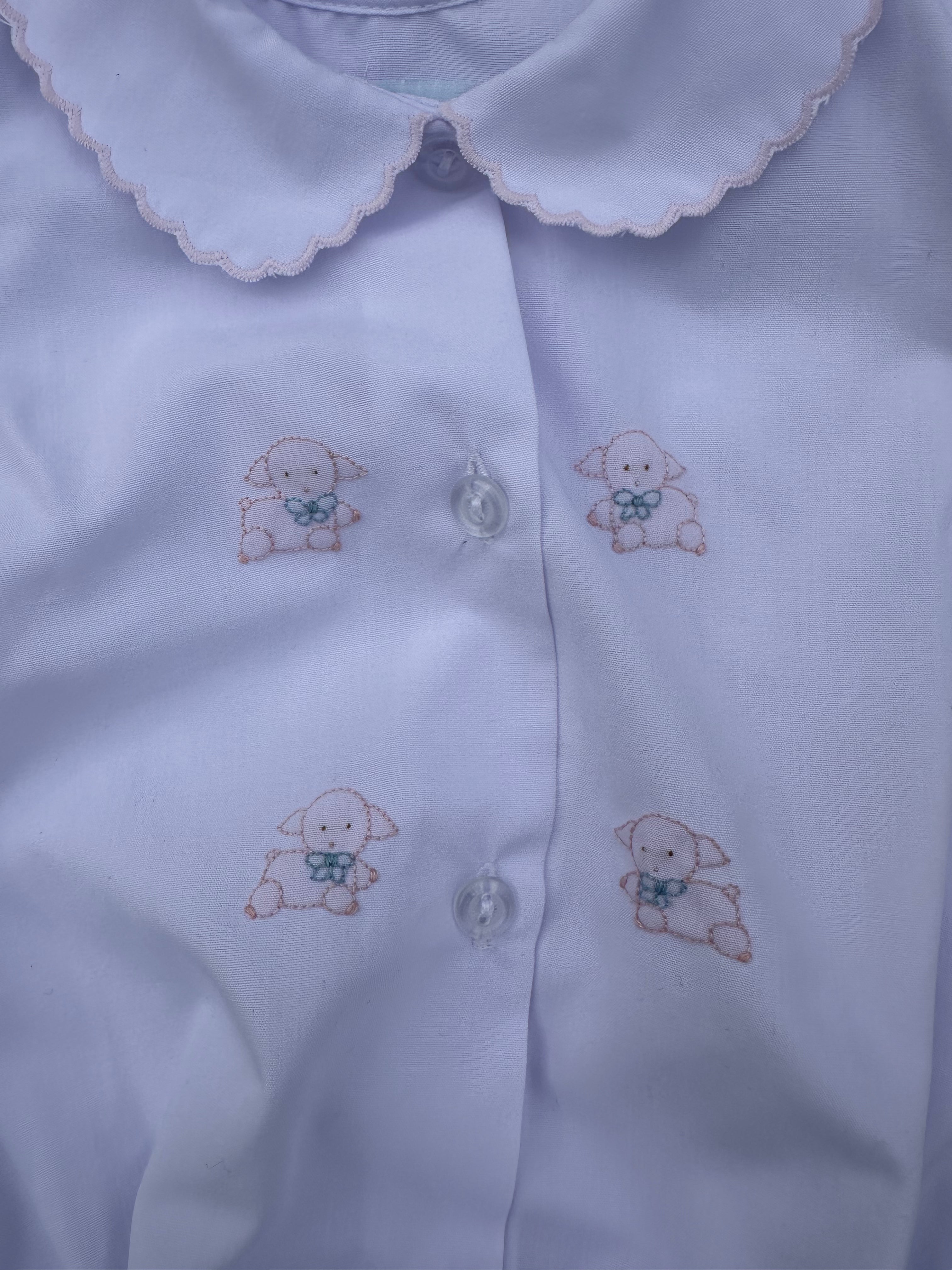 White Bubble with embroidered lamb designs on a plain background